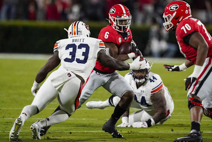 Georgia Bulldogs running back Kenny McIntosh (6) runs against Auburn Tigers linebacker K.J. Britt (33) during the first half at Sanford Stadium.